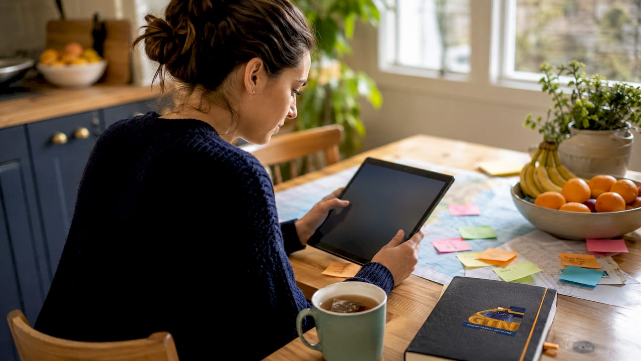 user working on itinerary builder app at home desk