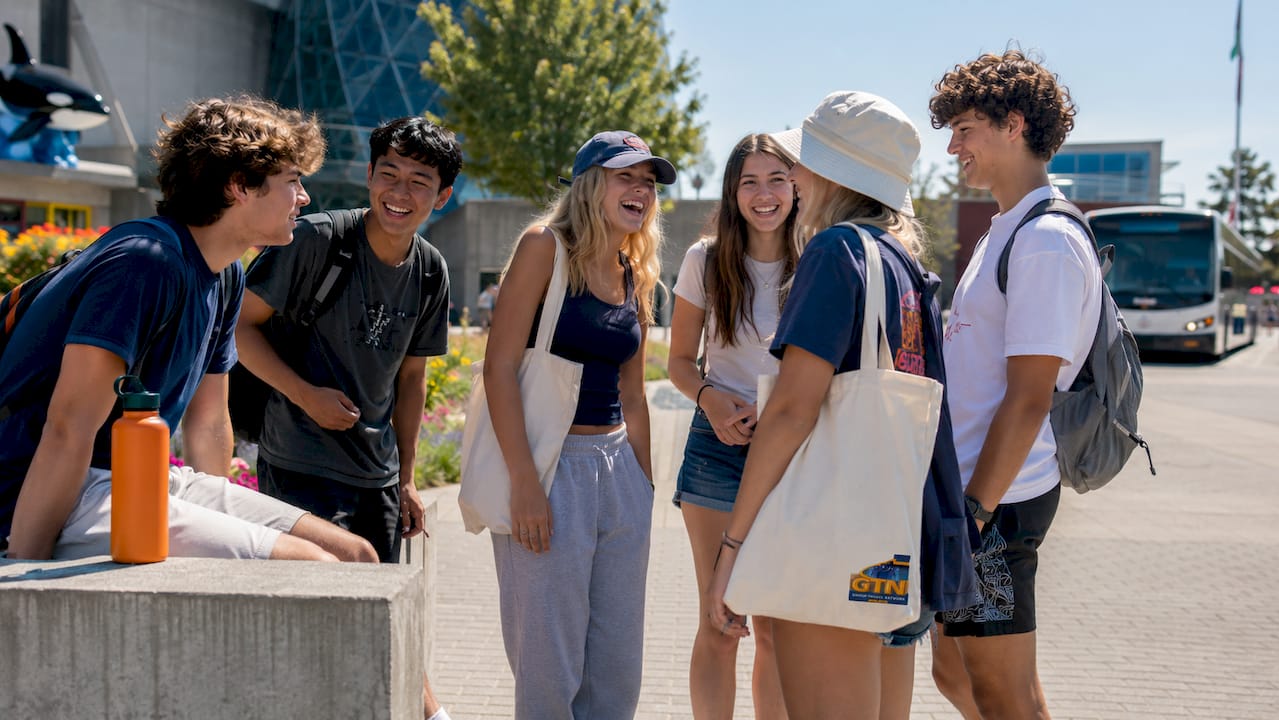 students waiting for bus at museum transit stop