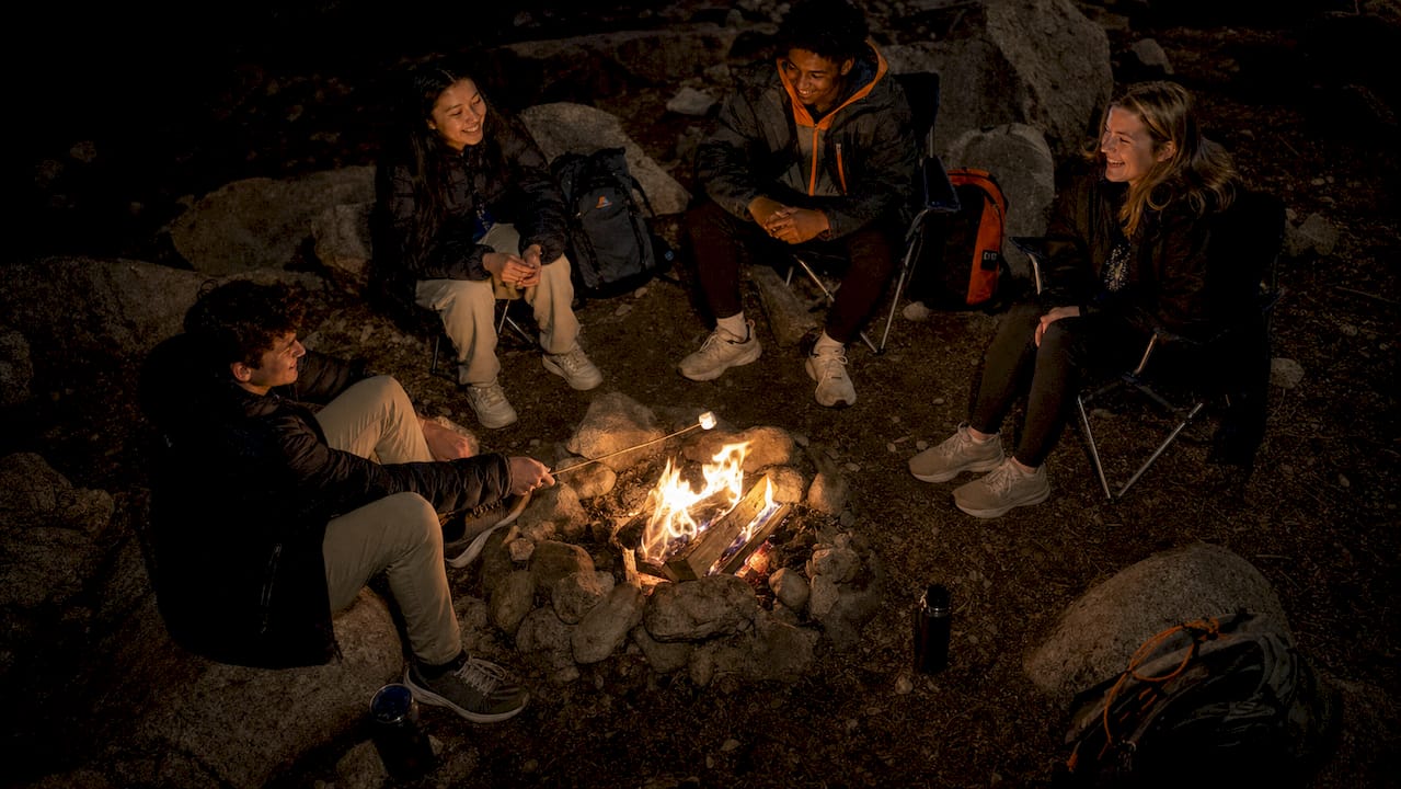 best southwesterntravel.com alternatives for groups in 2026 5 students enjoying southwestern desert campfire at night