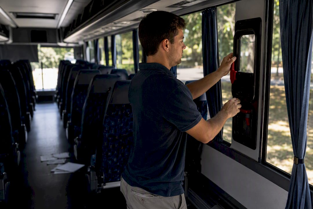 checking seatbelt on charter bus interior