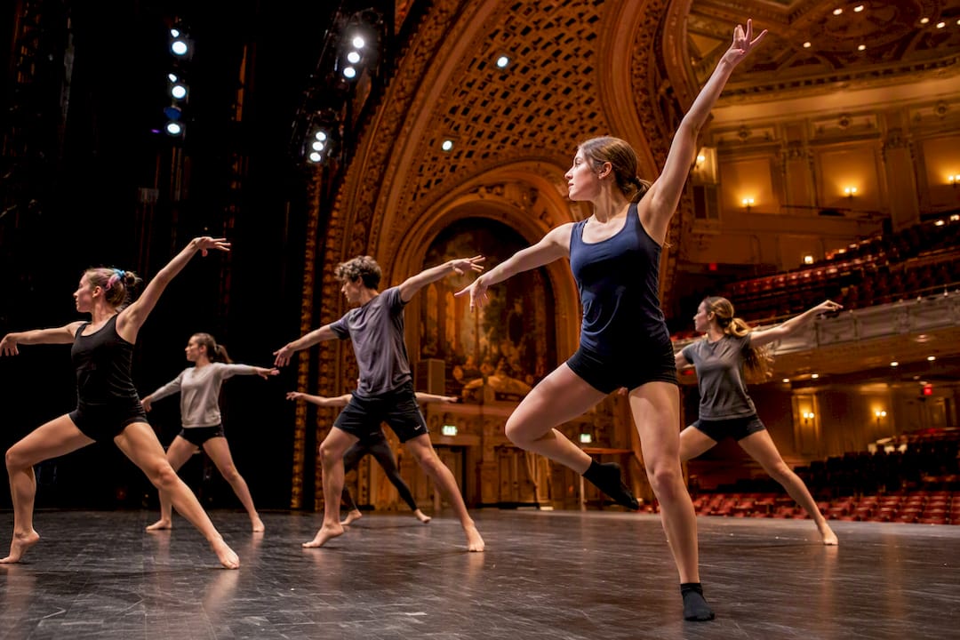 students dancing on harris theater stage