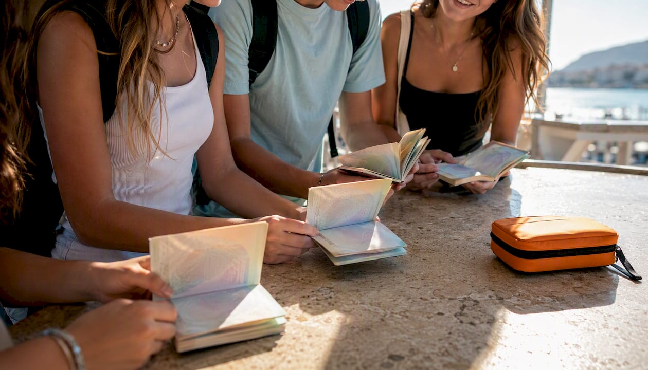 students reviewing passports before destination entry