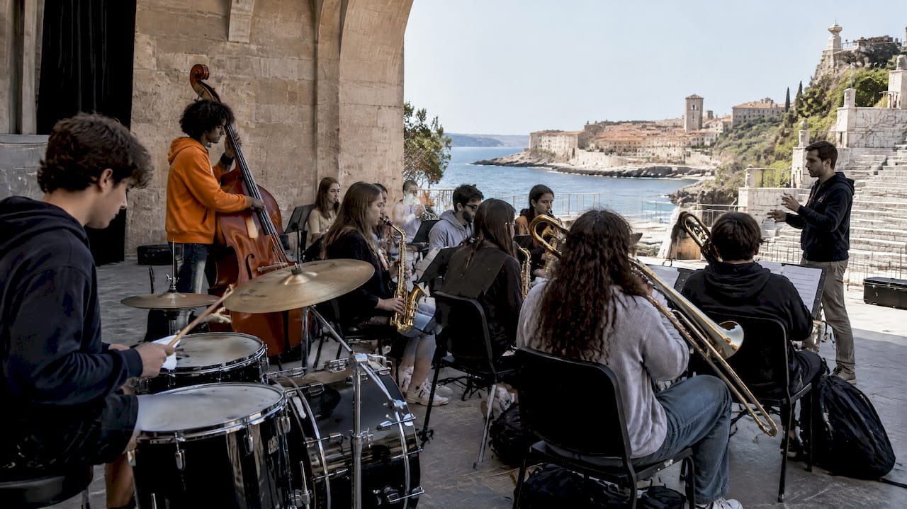 Students practice positions in an open-air amphitheater